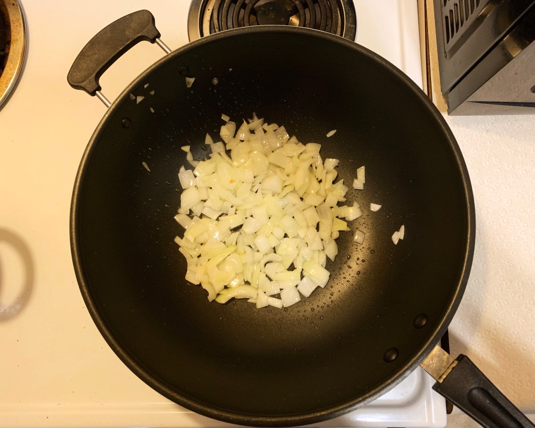 Onions cooking in a pan.