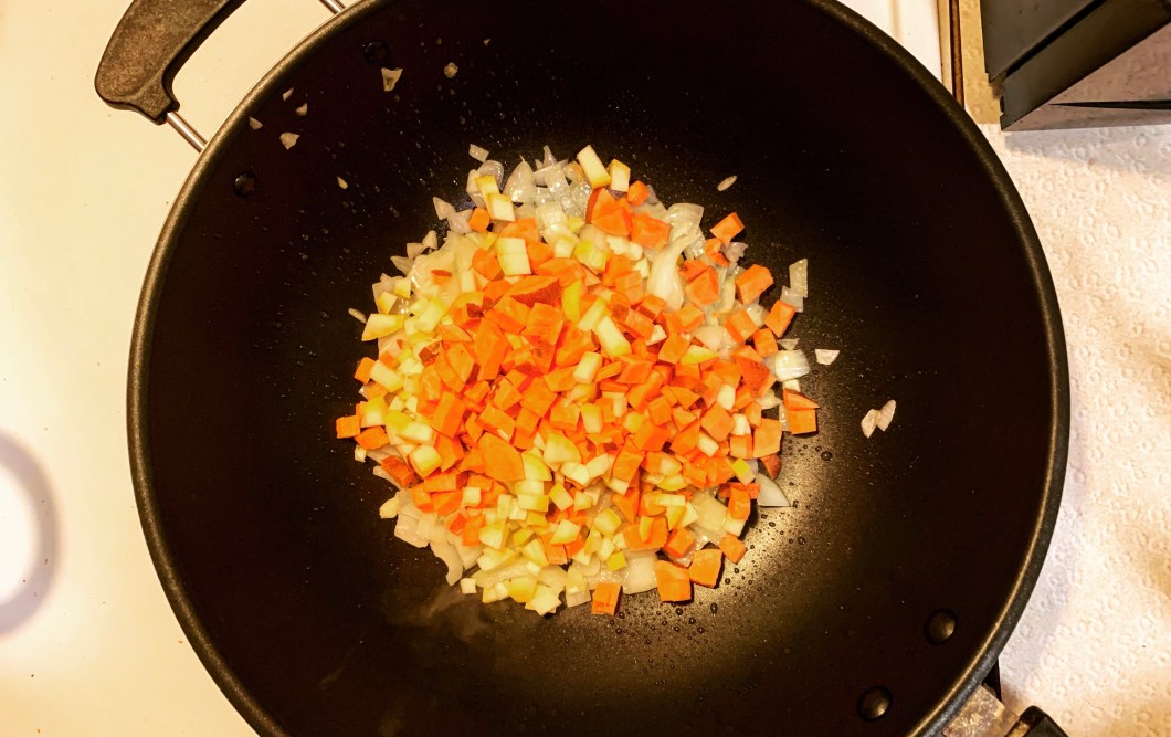 sweet potatoes, squash, and onions cooking in a pan