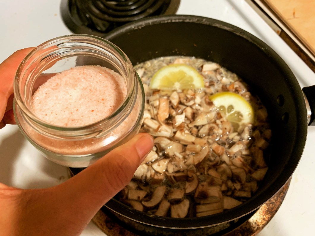 Making rice with pink salt, lemon, and mushrooms.