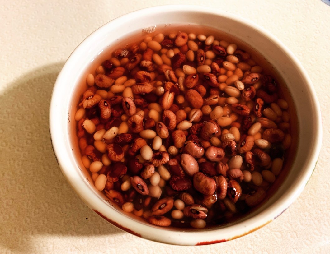 chili beans and white beans soaking in a bowl