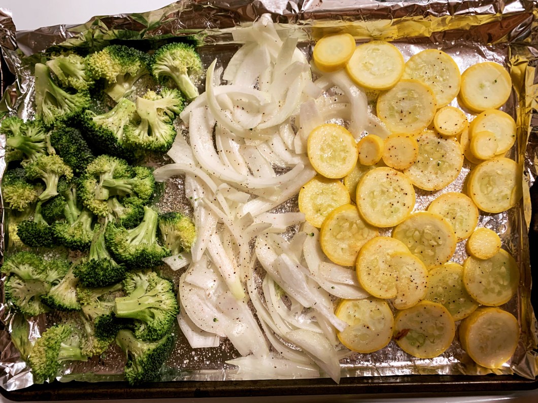 Baking veggies like broccoli, onions, and yellow squash