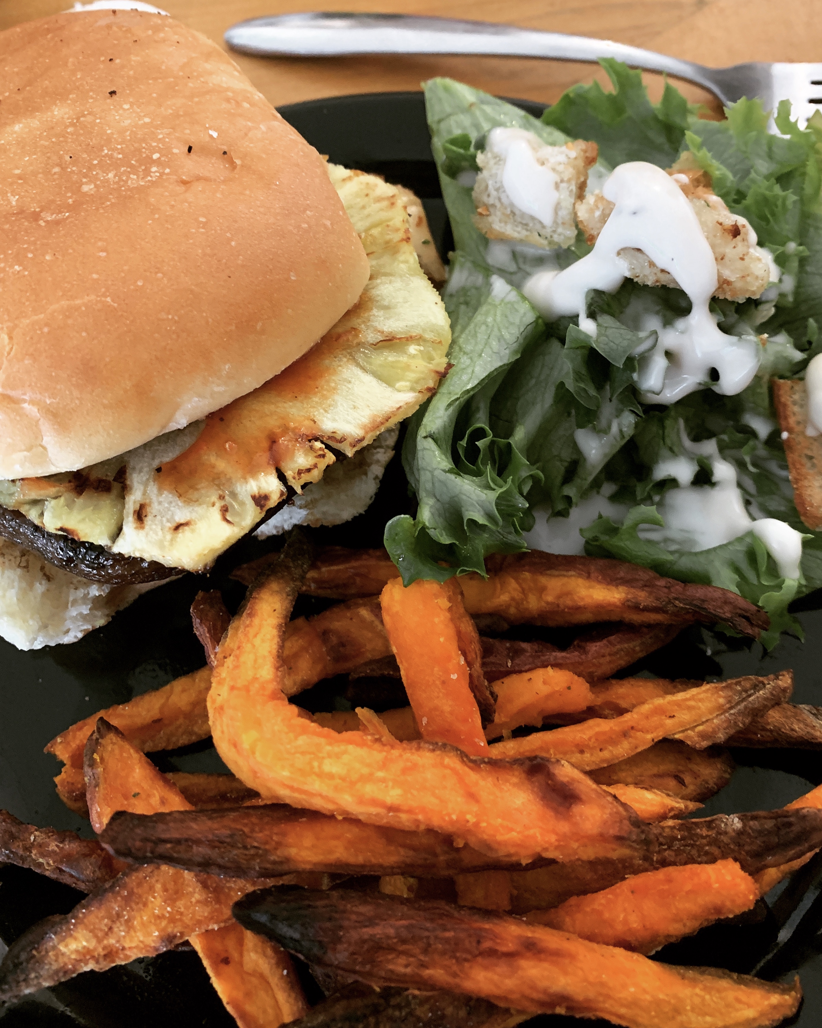 Vegan Mushroom Burger with sweet potato fries and vegan caesar salads 