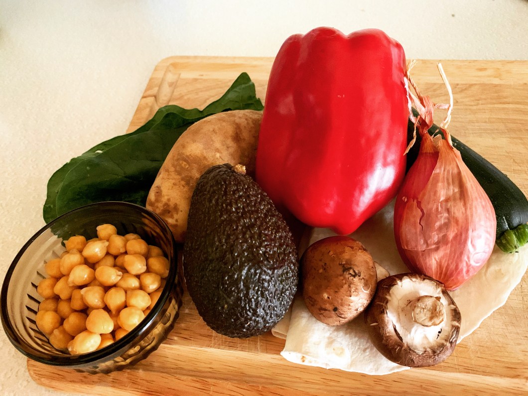 vegetables for vegan chipkpea breakfast burrito: red bell pepper, potatoes, avocado, shallot, mushroom, spinach, chickpeas, and tortillas
