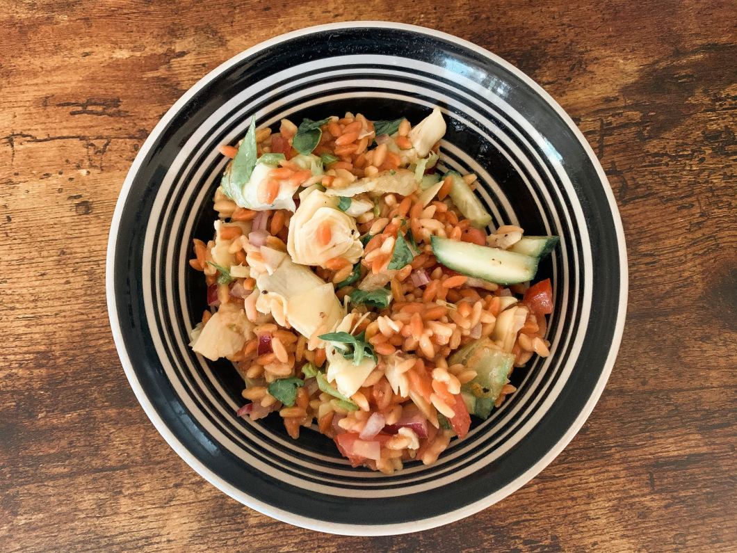 colorful veggies in a vegan greek orzo salad