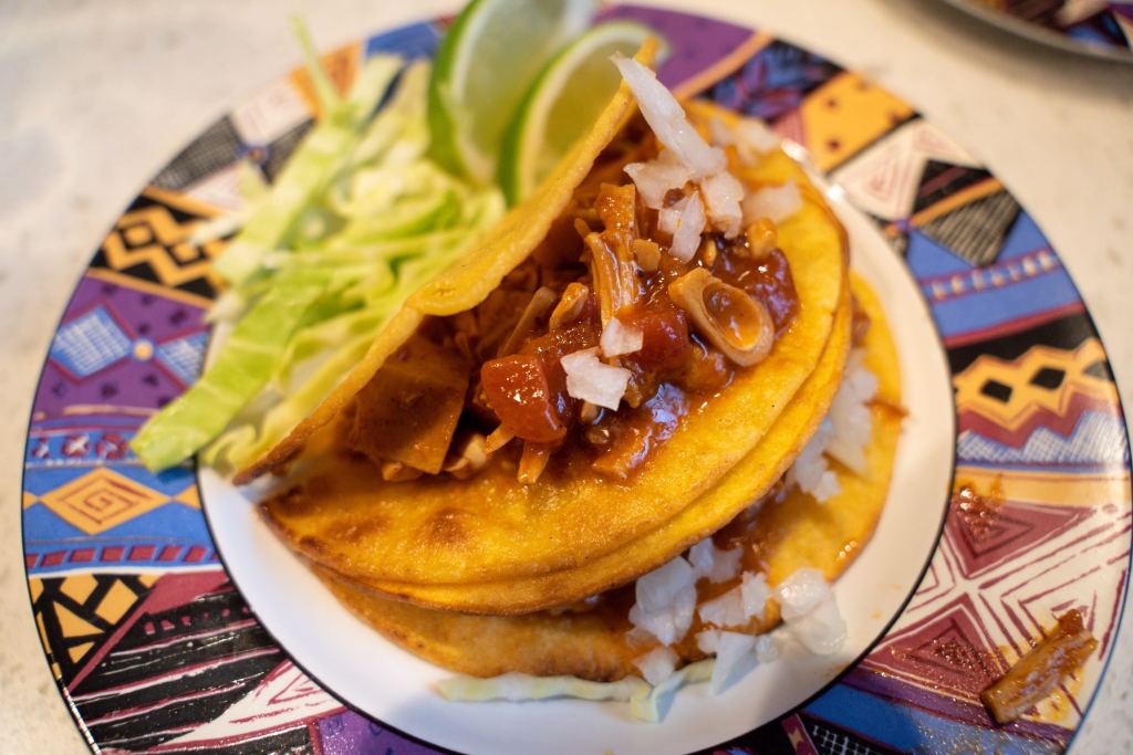 Spicy Chipotle Vegan Jackfruit Tacos with Lime and Green Cabbage in Taco Shells